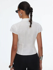 Blusa de manga corta con cuello mandarín y botones de nudo